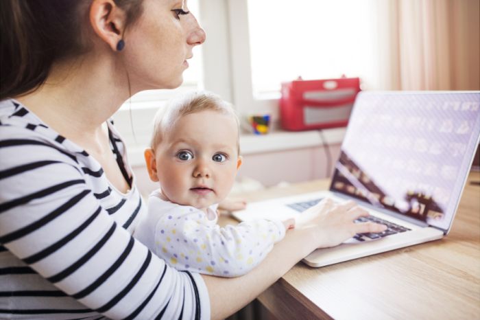Young,Mother,In,Home,Office,With,Computer,And,Her,Daugher