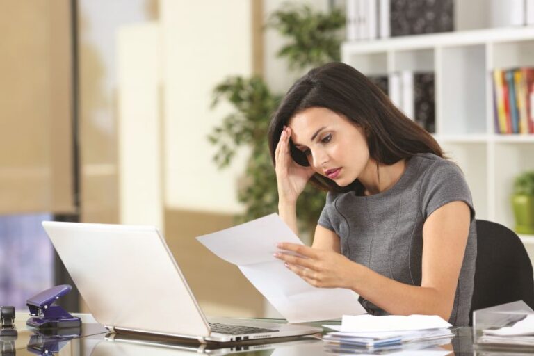 Worried,Office,Worker,Complaining,Reading,Bad,News,In,A,Paper